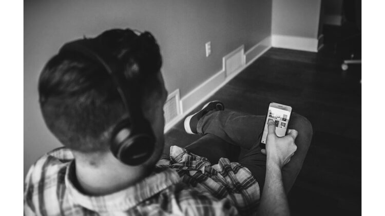 'The Cautionary Tale of Phone Addicted Mimi': A Poem by Paul A. Freeman 1 photo of person looking at smart phone with headphones on (public domain)
